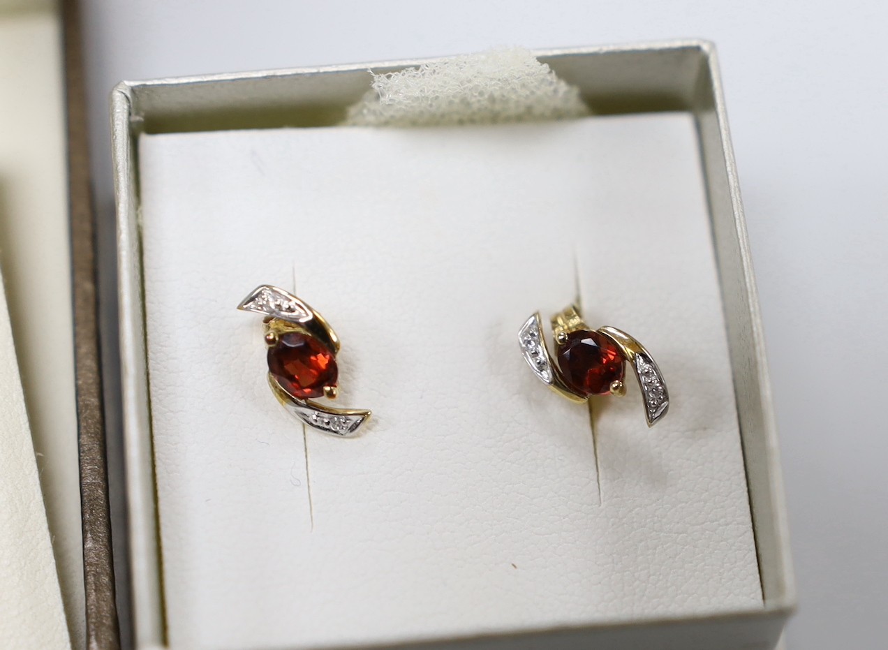 Three assorted modern pairs of yellow metal earrings, including tassel drop, 9ct gold and three stone sapphire (lacking butterflies) and 375 garnet and diamond chip